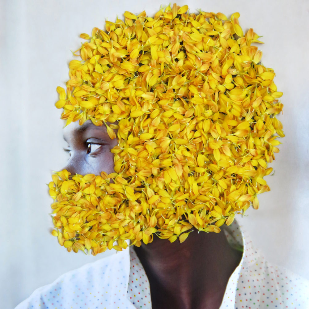 Women's head covered with yellow flowers